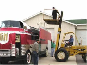 Futurliner getting the left side added on by a crane