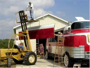 Futurliner getting the right side added on by a crane
