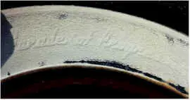 Original white tire walls that say "Parade of Progress"