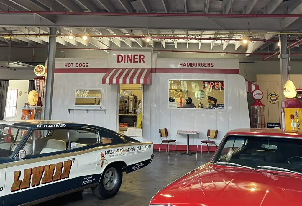 An old replica diner with two cars outfront