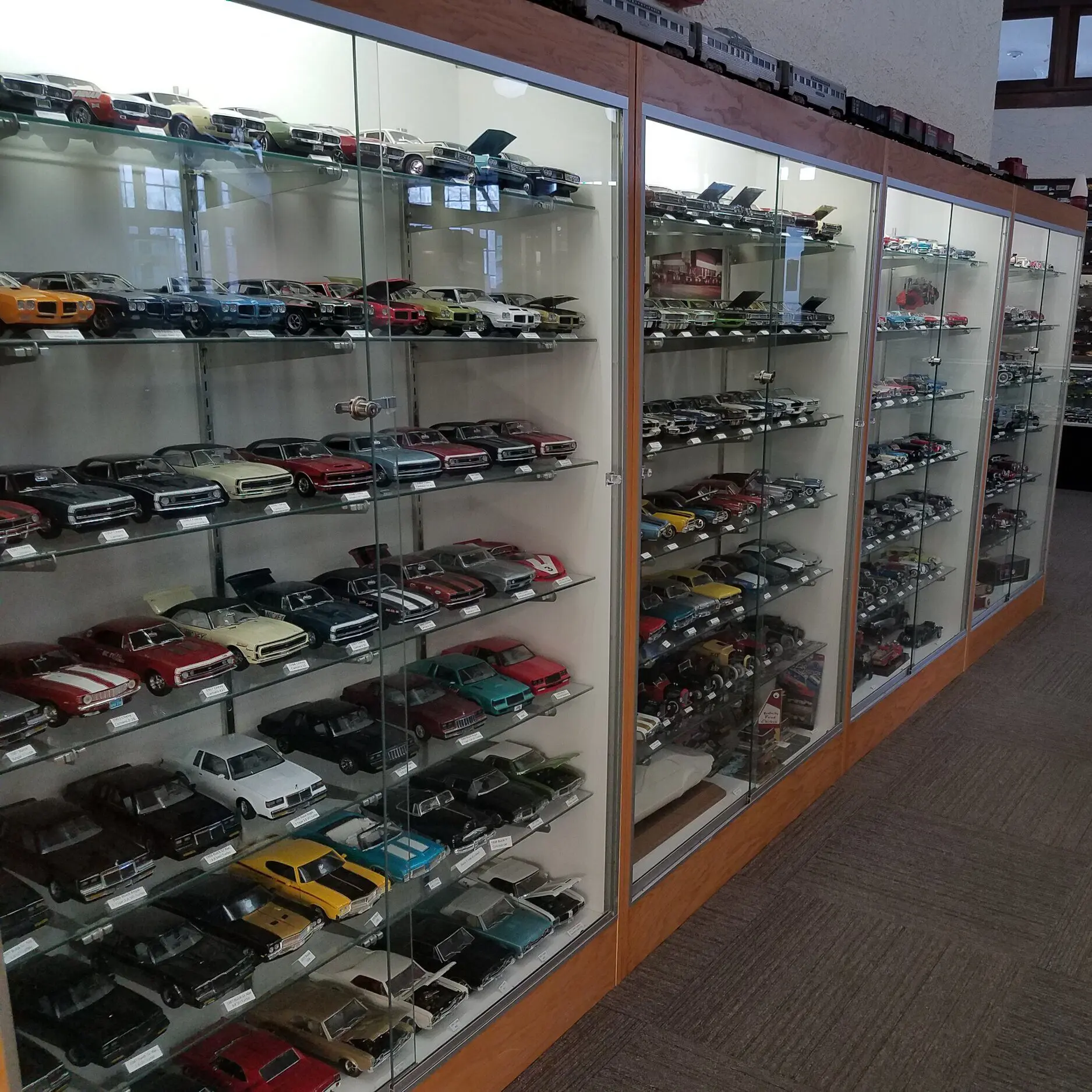 Glass Case of Model Toy Cars and Trucks