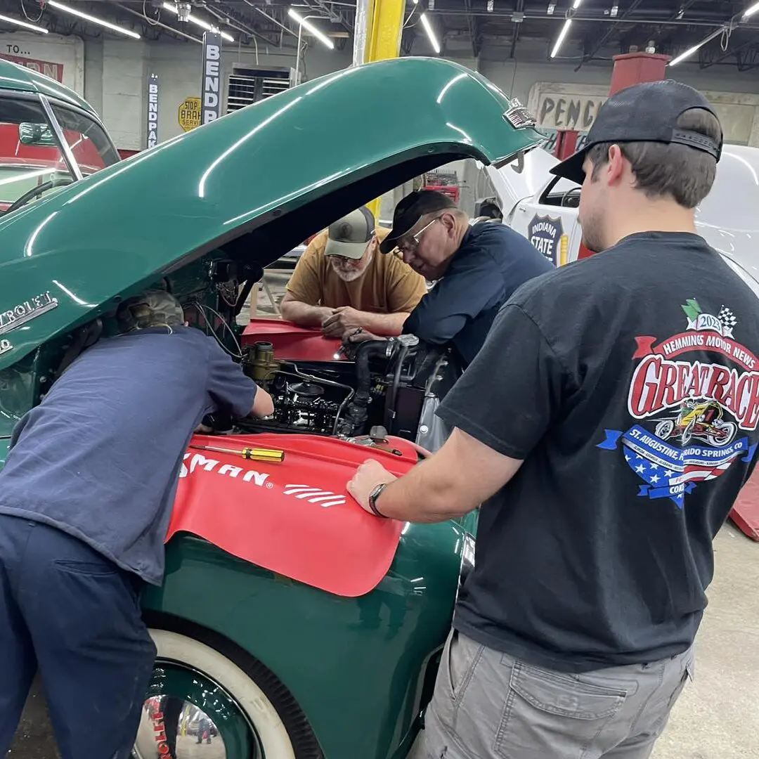 Youth and Volunteers work on an old truck