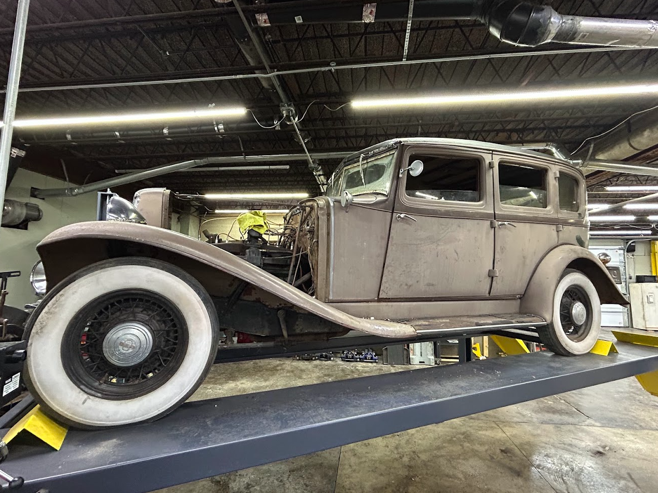 Auburn car on a lift in a repair shop